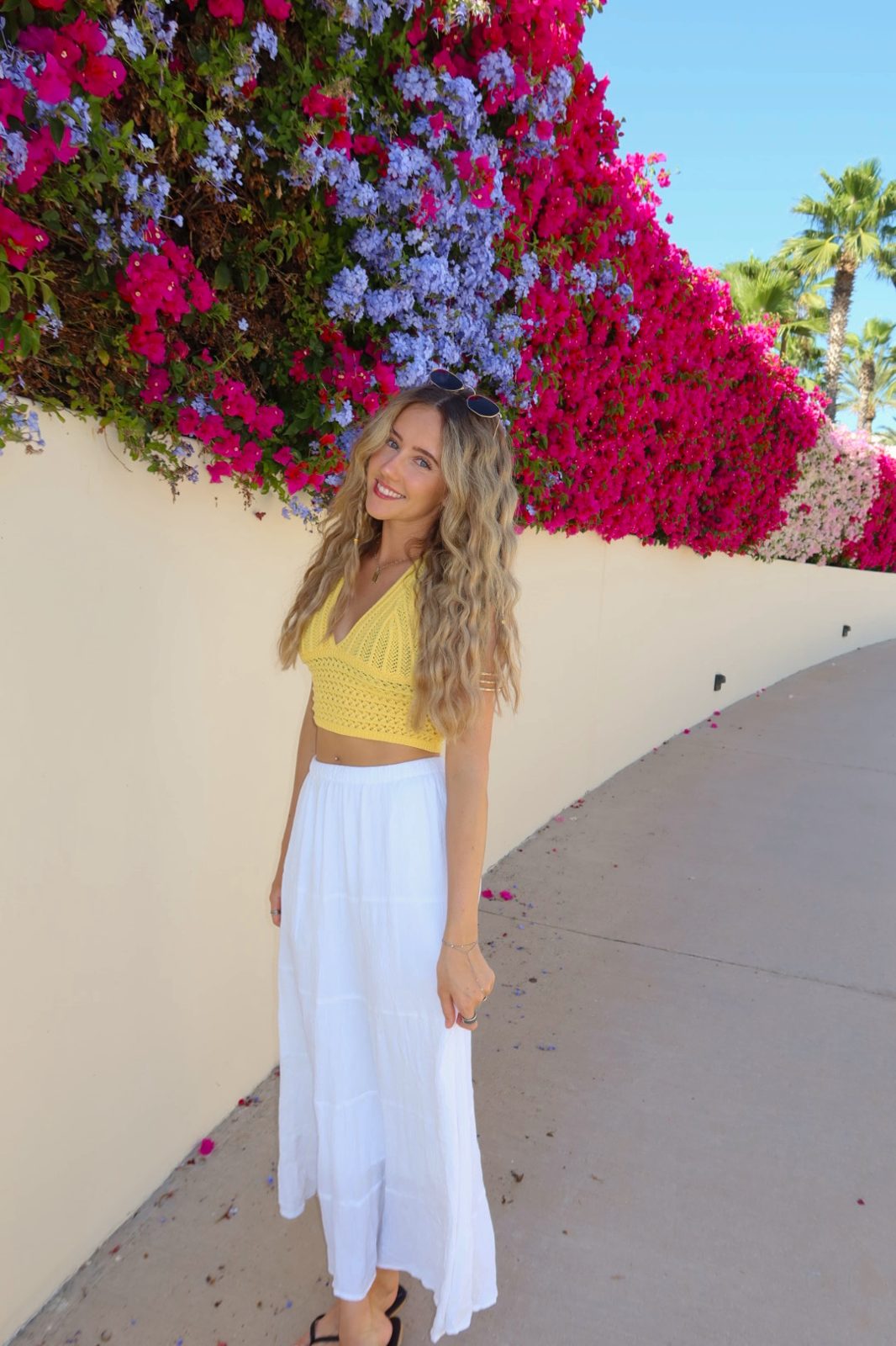 Bailey in a yellow top by the bougainvillea